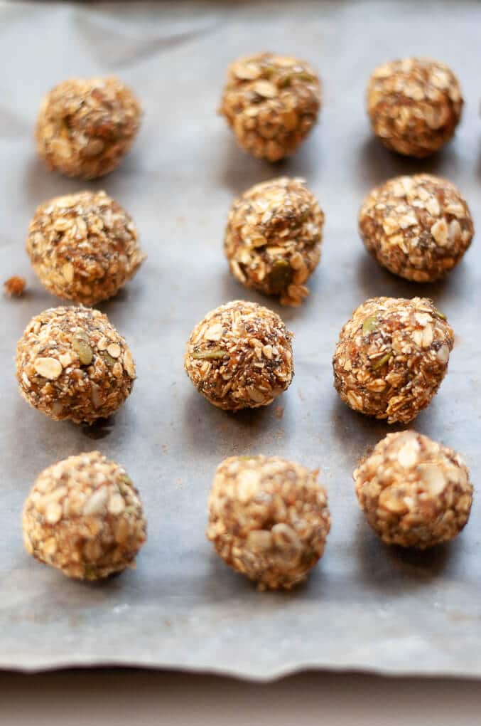 Four rows of trail mix energy bites on a piece of parchment paper