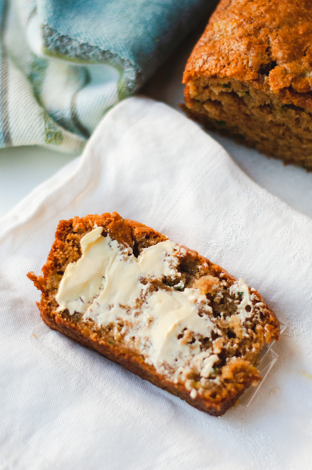 Slice of zucchini bread with butter.