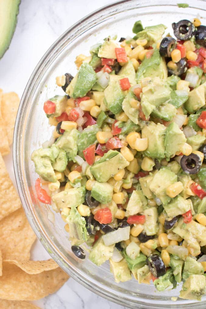 Avocado and corn salad in glass bowl