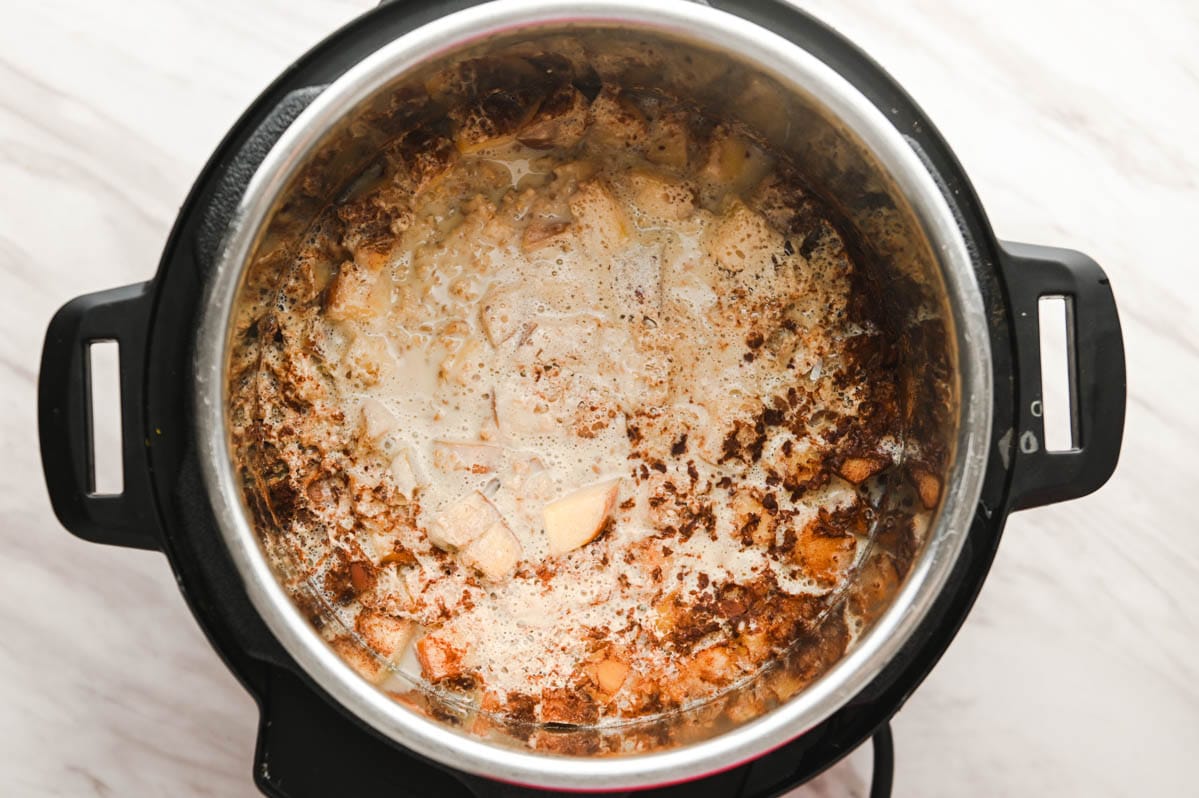 Instant pot with creamy steel cut oats before stirring.