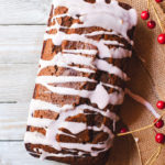 Vegan gingerbread loaf drizzled with cranberry icing