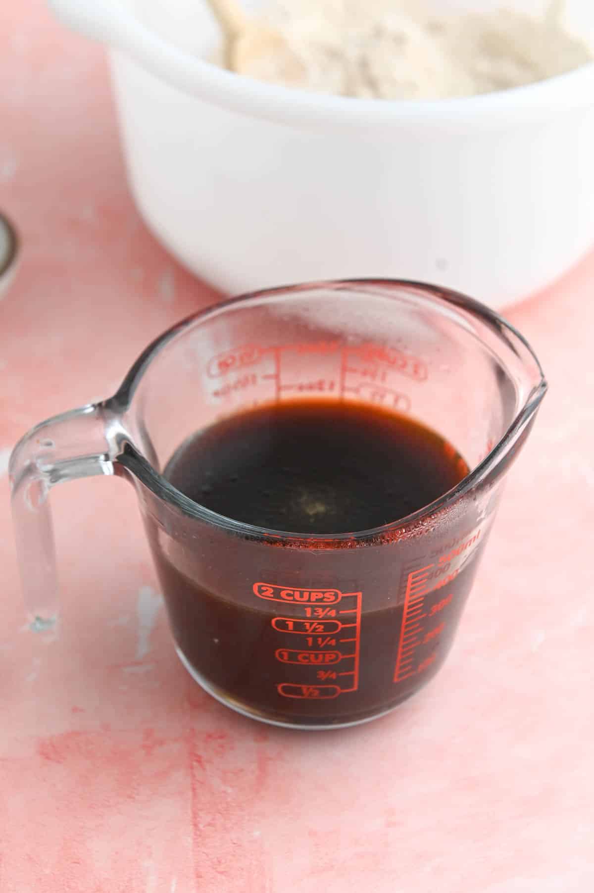 Molasses in a glass measuring cup.