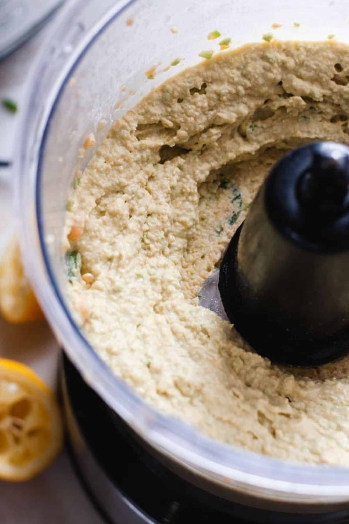 Hummus in food processor after being pureed.