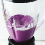 Fully blended blueberry ingredients in a glass blender.