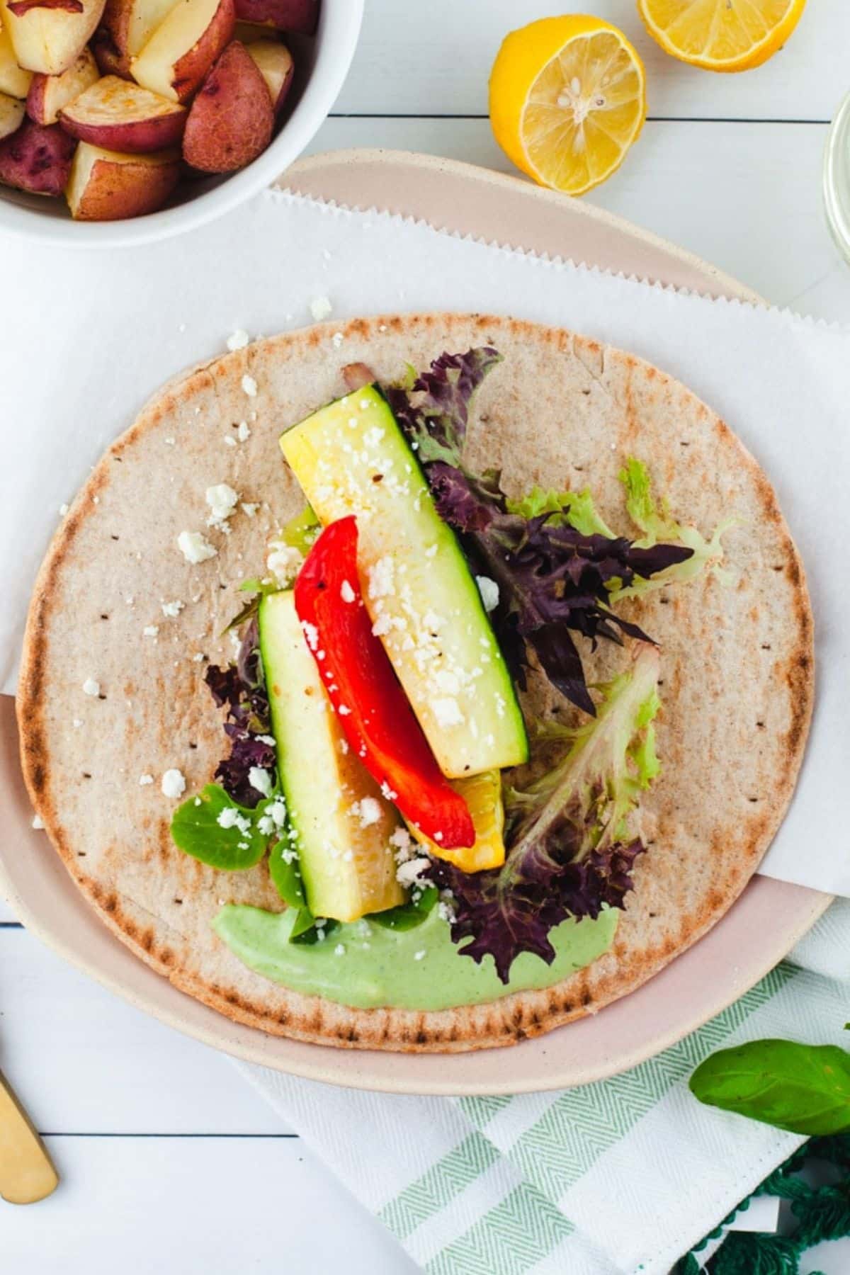 Whole wheat pita topped with romaine lettuce, green aioli, and roasted vegetables.