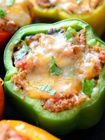 Close up of green bell pepper topped with melted cheese.