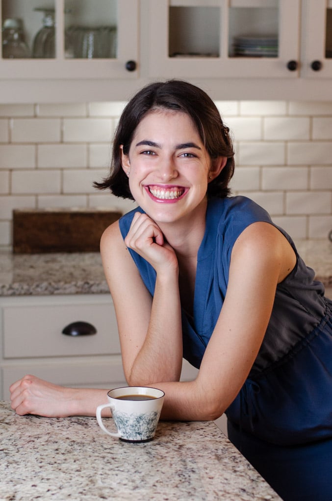 Woman smiling and leaning on countertop