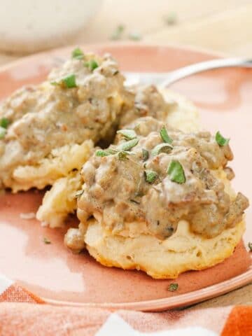 Vegan biscuits and gravy on a pink plate.