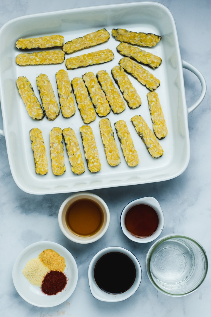 Ingredients used to make tempeh bacon on a marble background