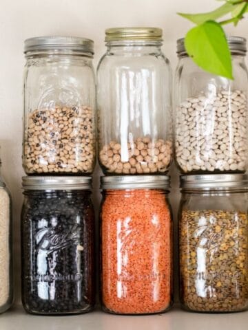 Stack of glass jars with beans in them.