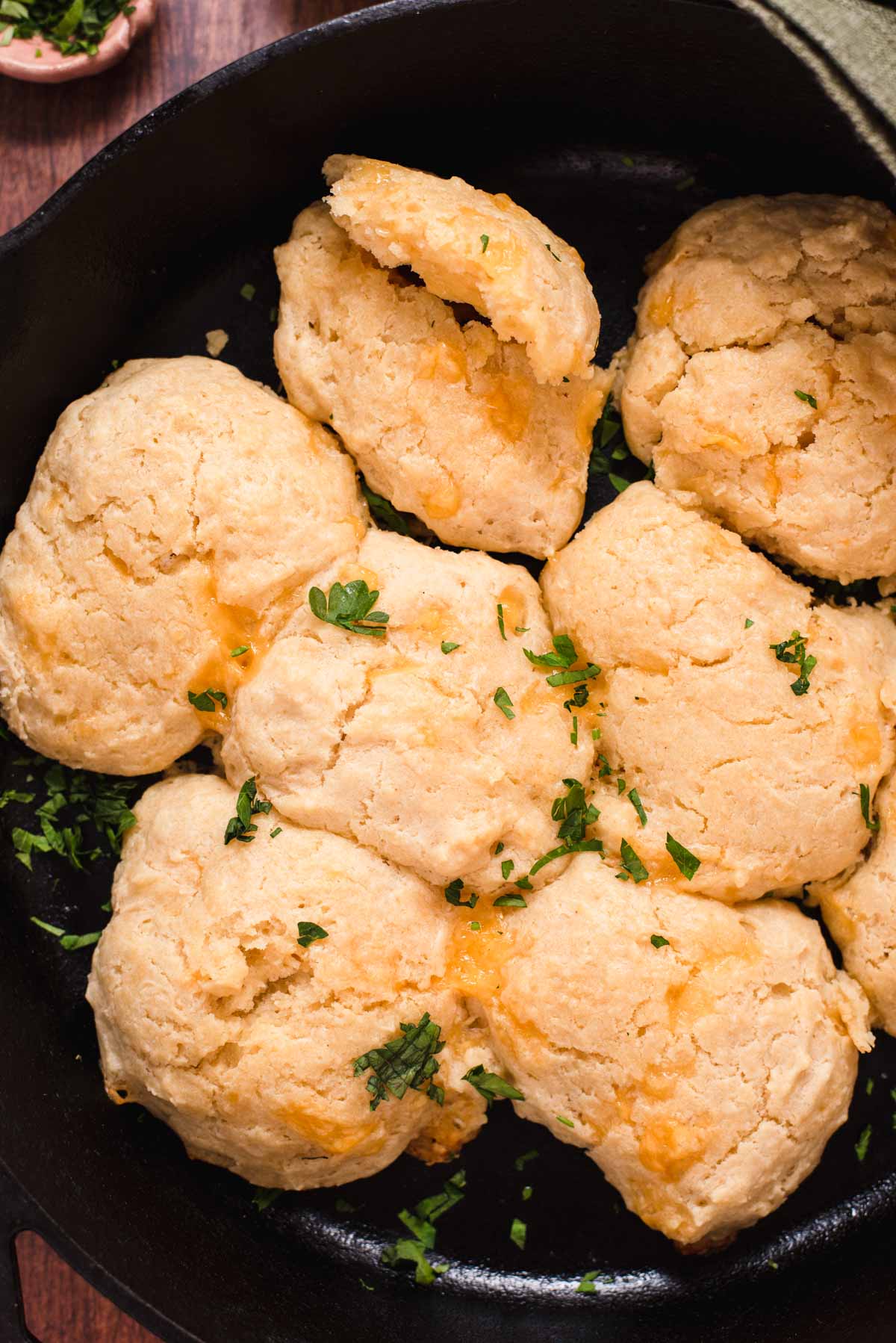 Close up view of drop biscuits in a cast iron pan