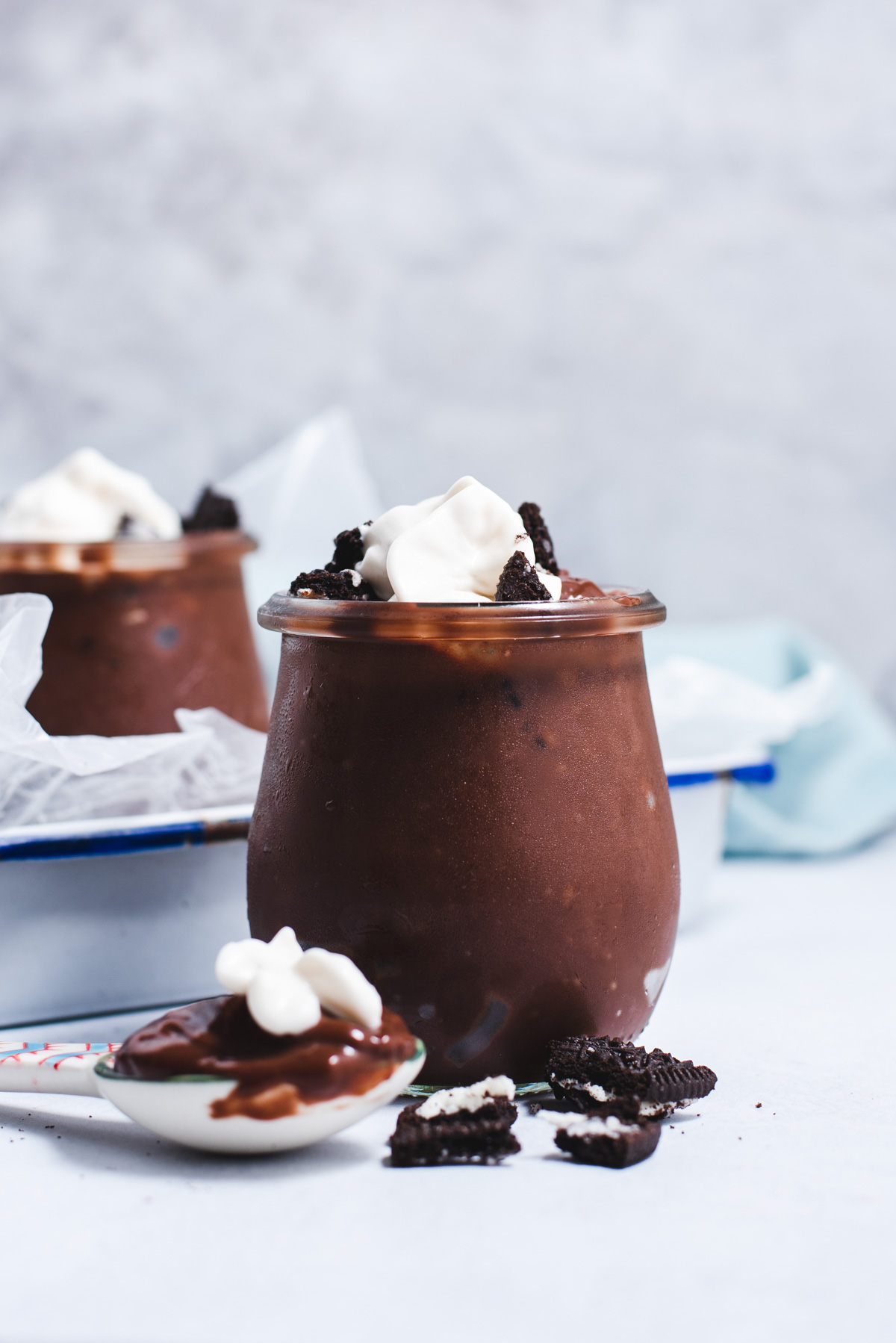 Small glass jar filled with chocolate pudding.