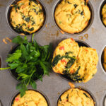 Muffins and fresh parsley in a metal muffin tin