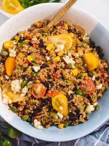 Quinoa salad in a white and blue bowl.