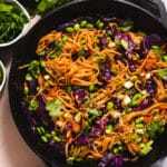Black cast iron pan filled with almond butter stir fry
