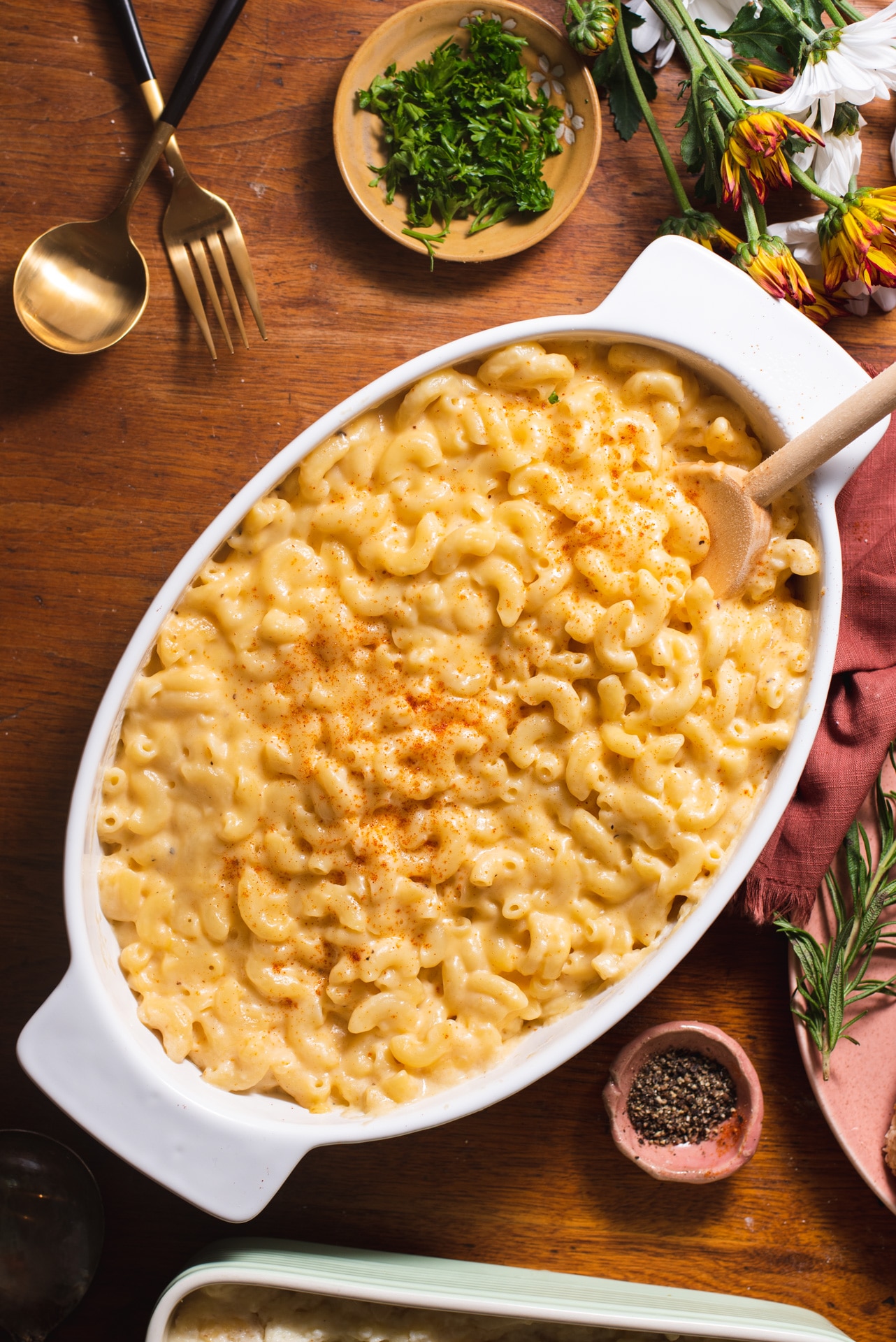 Overhead view of white dish holding mac and cheese on a wooden background