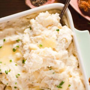 Garlic cream cheese mashed potatoes topped with butter and chives.