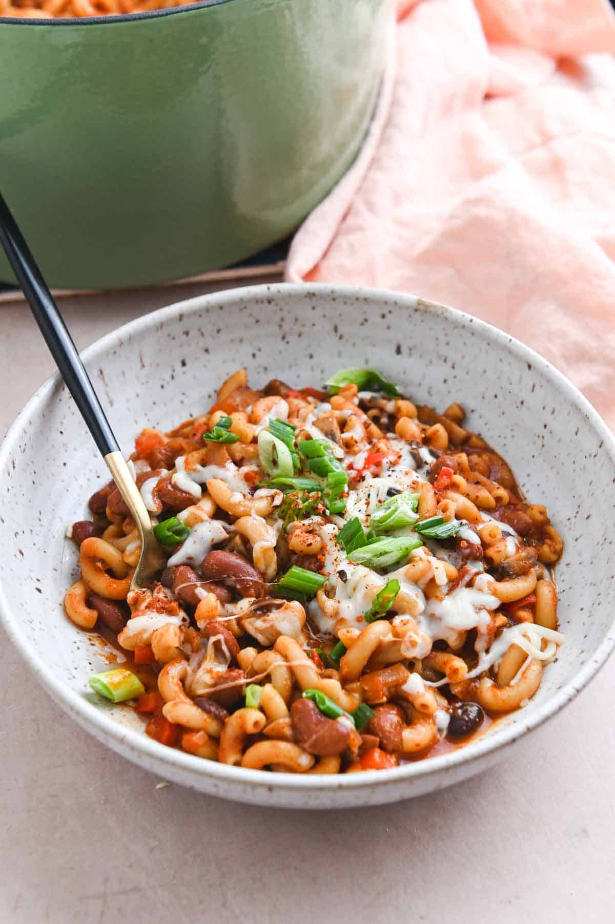 White bowl filled with chili mac.