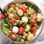 Bowl with spinach, mozzarella, chickpeas and tomatoes on spinach.