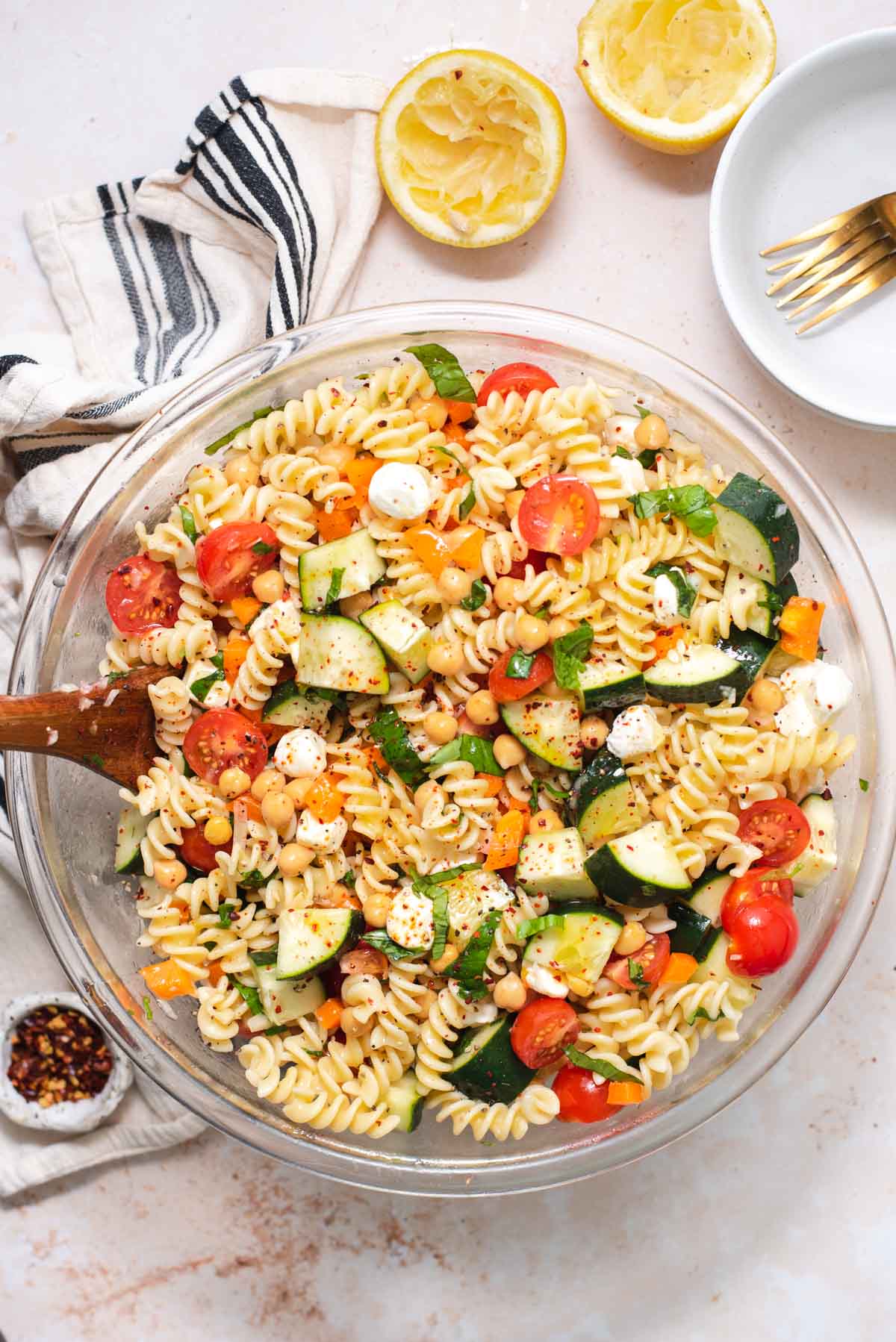 Overhead view of large glass bowl filled with pasta salad 