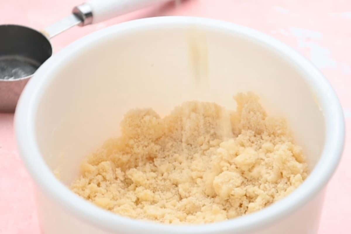 Crumb topping in a white mixing bowl