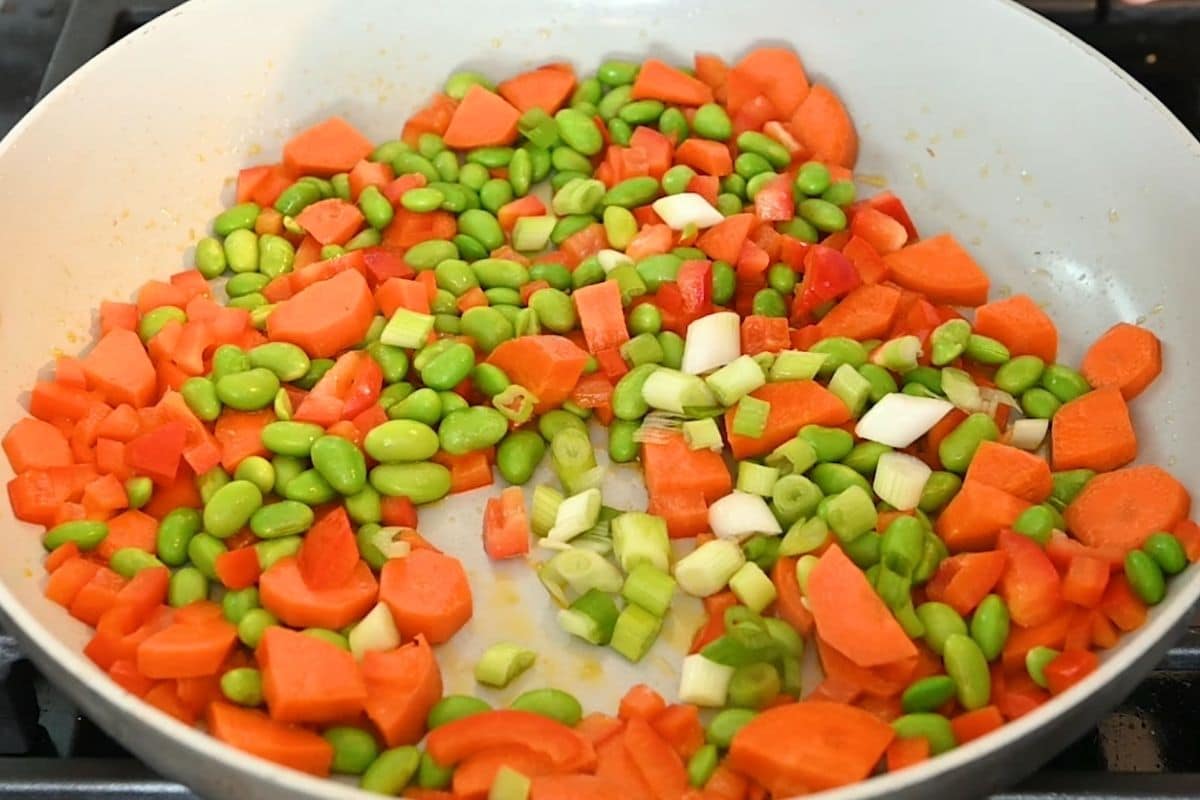 Carrots, peppers and green onion in a skillet