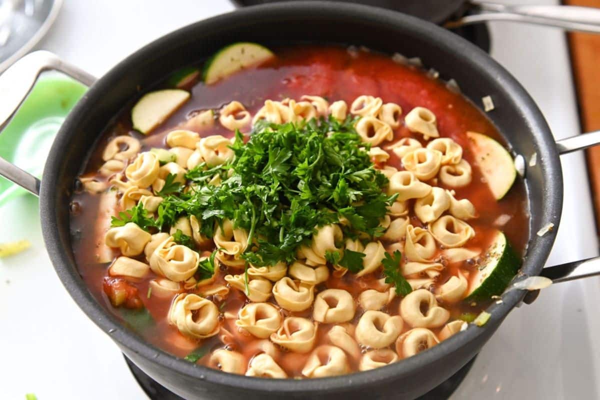 Tortellini and parsley in a dutch oven.