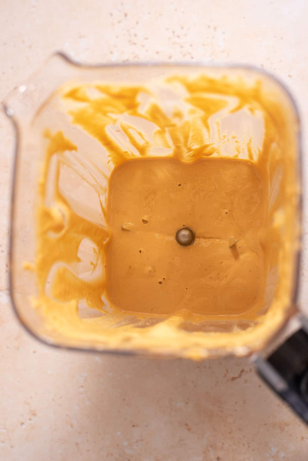 Yellow creamy sauce in a plastic blender