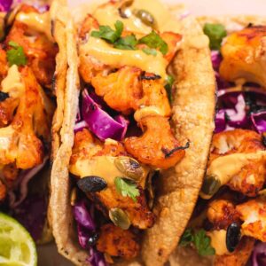 Taco filled with roasted cauliflower, purple cabbage and cilantro