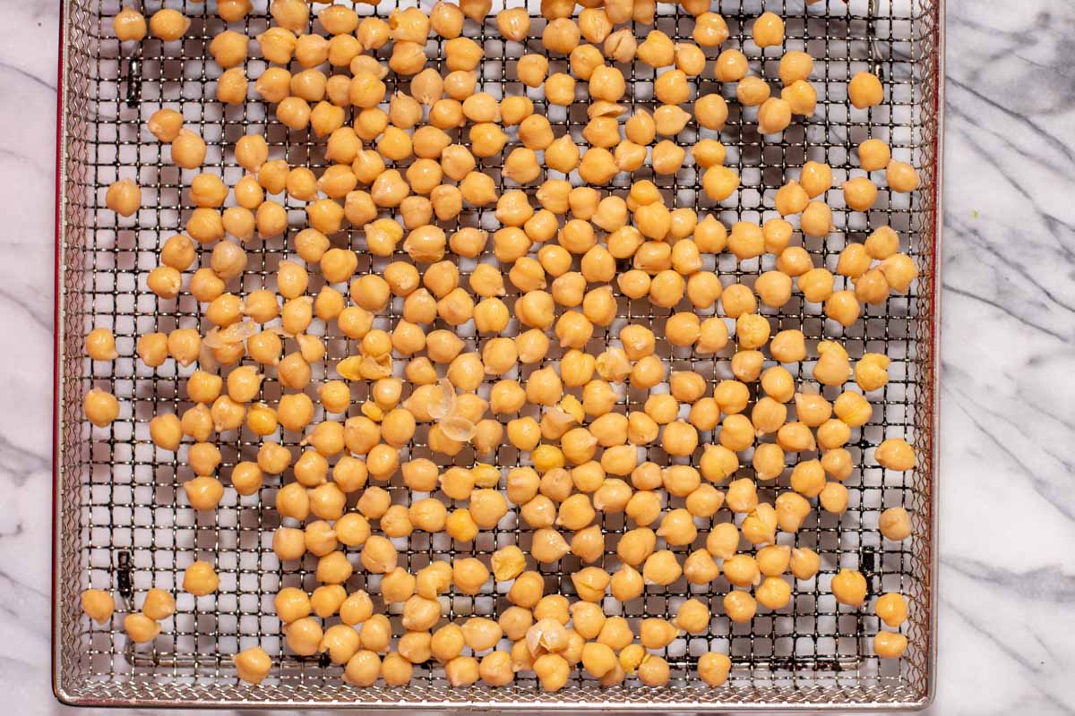Chickpeas spread out on wire air fryer rack
