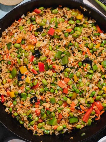 Fried rice with vegetables in a cast iron skillet