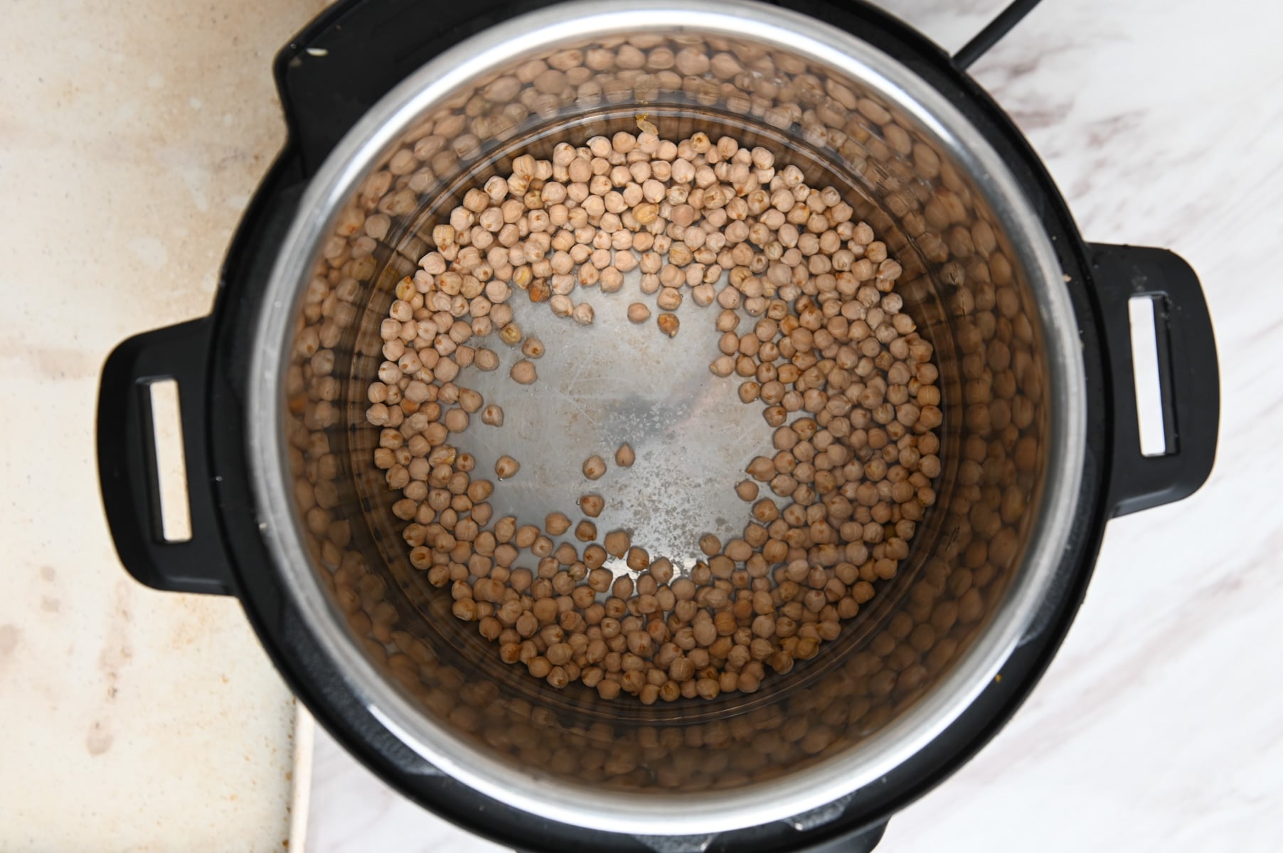 Dry chickpeas and water in an Instant Pot.