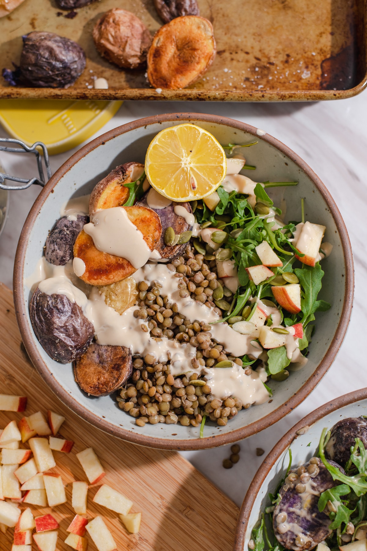 Overhead view of lentil bowl drizzled with tahini.