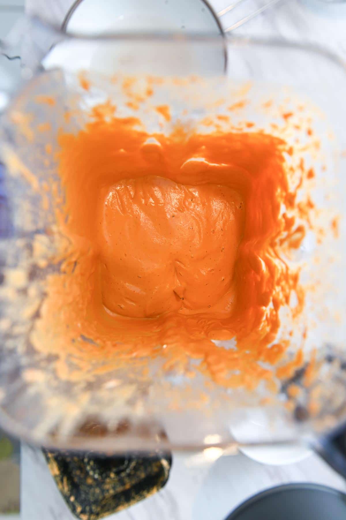 Orange cashew cream in a blender.