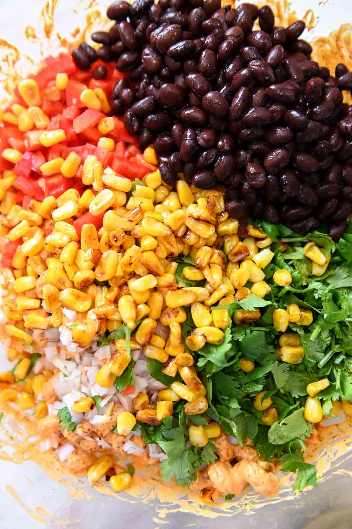 Corn, bell pepper, black beans, and cilantro in a bowl.