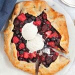Overhead view of berry galette topped with ice cream.