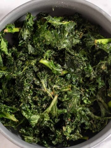 Gray bowl filled with kale chips.