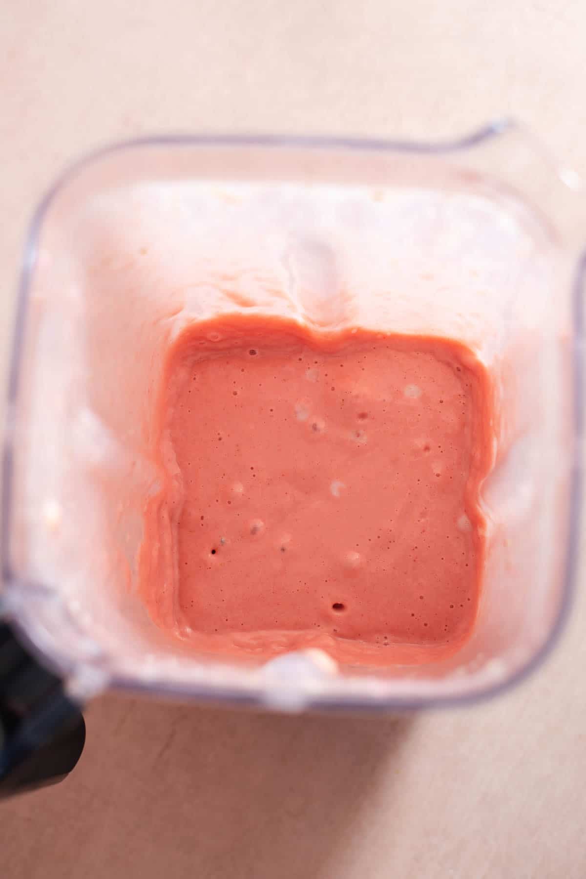 Pink smoothie in a blender.
