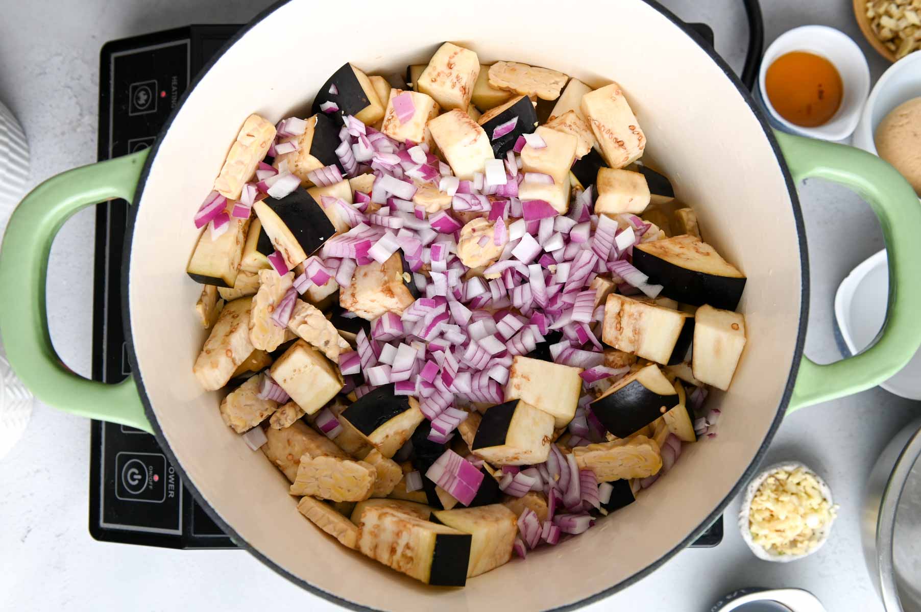 diced eggplant and red onion in a large Dutch oven.