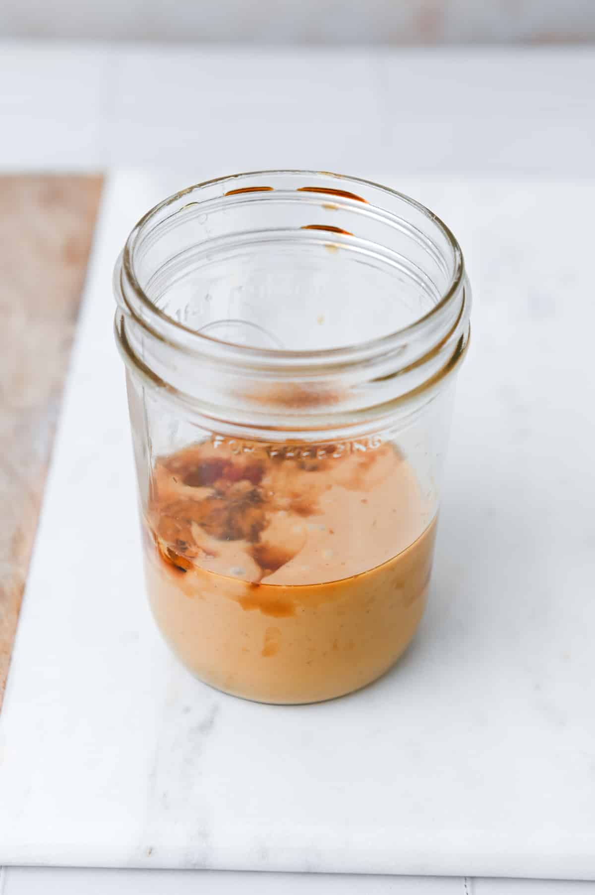 Peanut sauce ingredients in a glass jar.