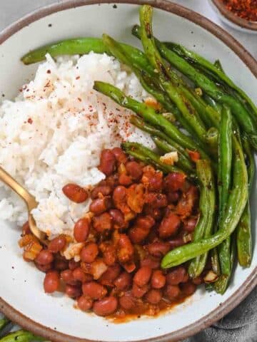 Red beans, rice, and green beans in a gray bowl.