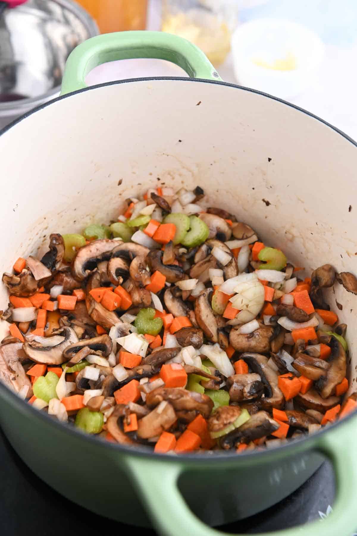 Mushrooms, celery, carrots, and onion in a Dutch oven.