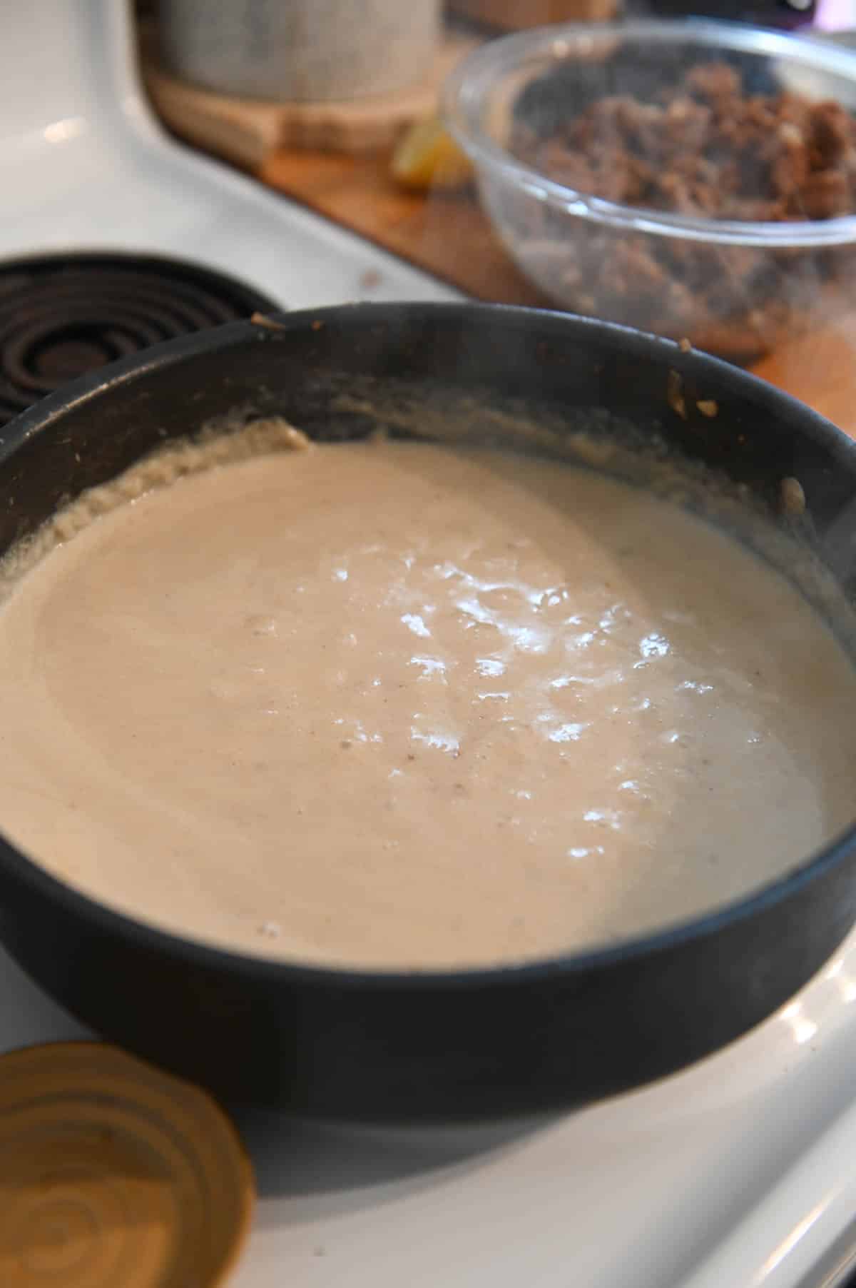 Bubbling roux in a black skillet.