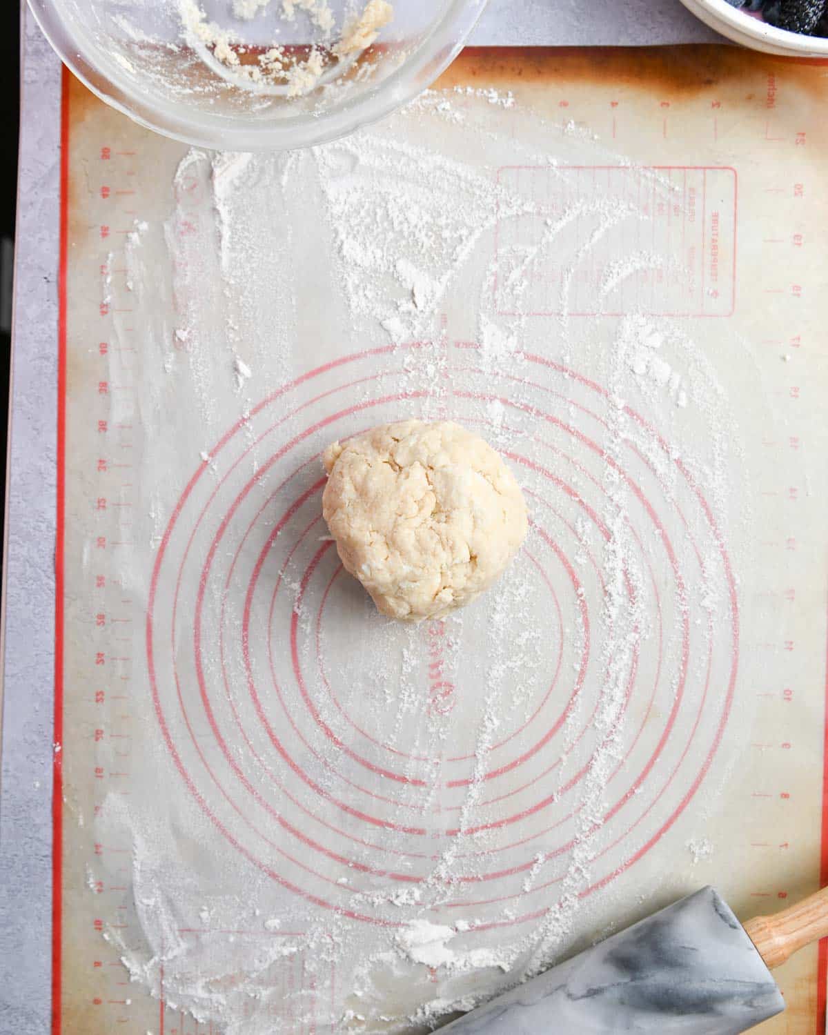 Ball of dough on a silicon baking sheet.