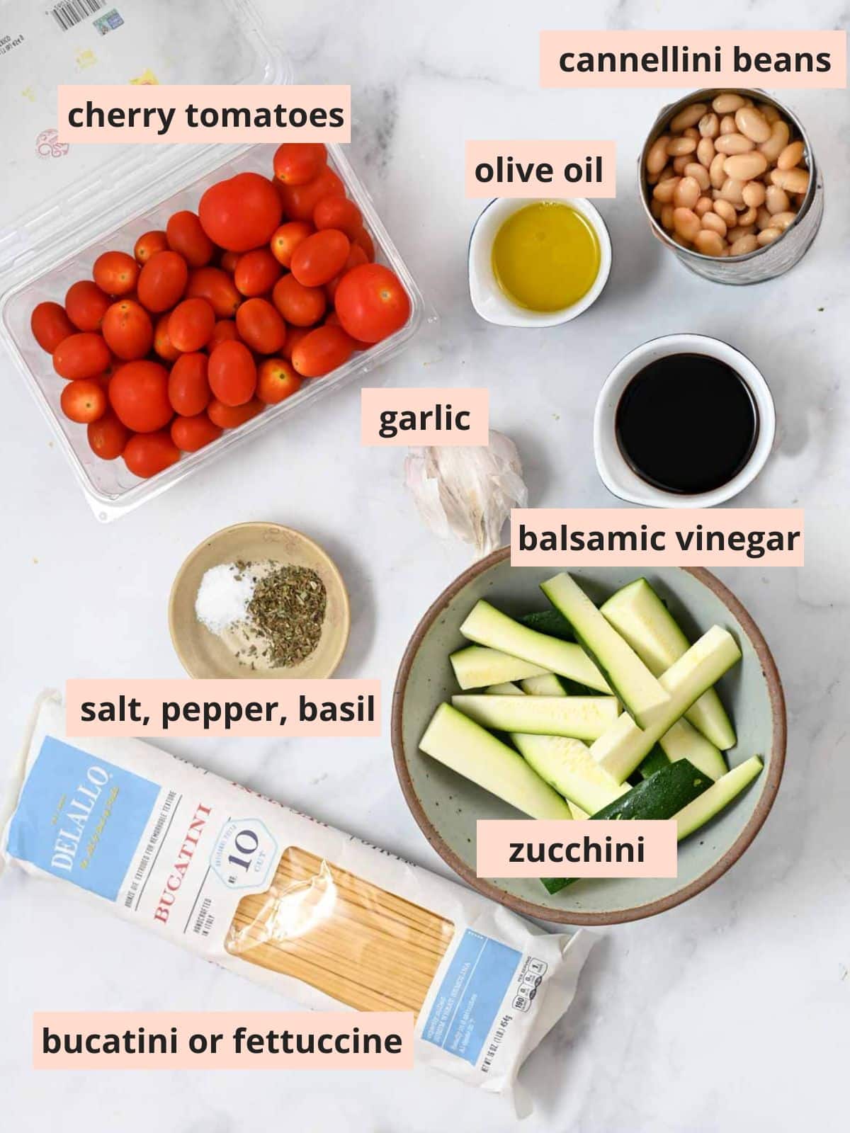 Labeled ingredients used to make tomato and zucchini pasta.