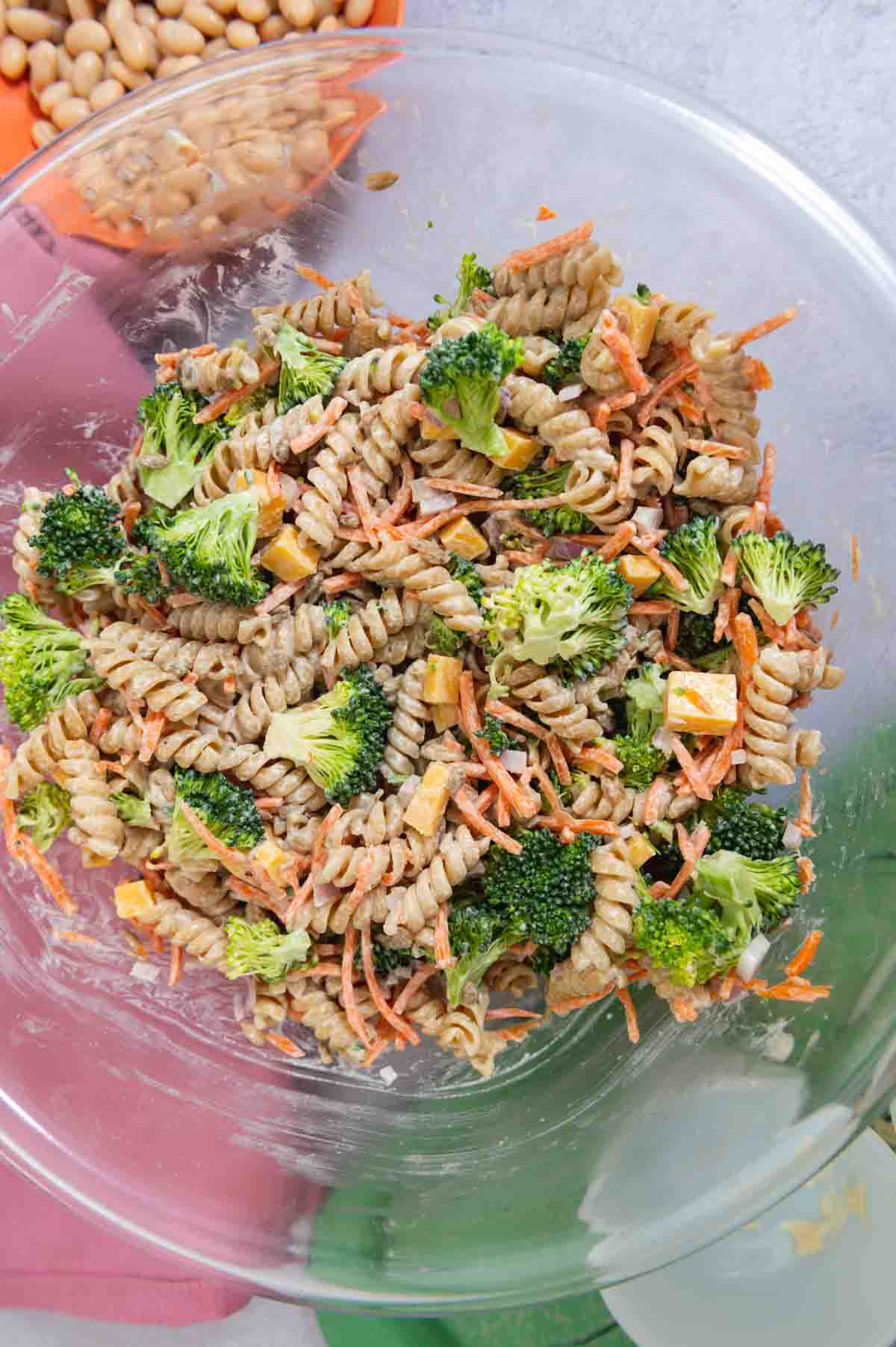 Large glass bowl filled with rotini pasta salad.