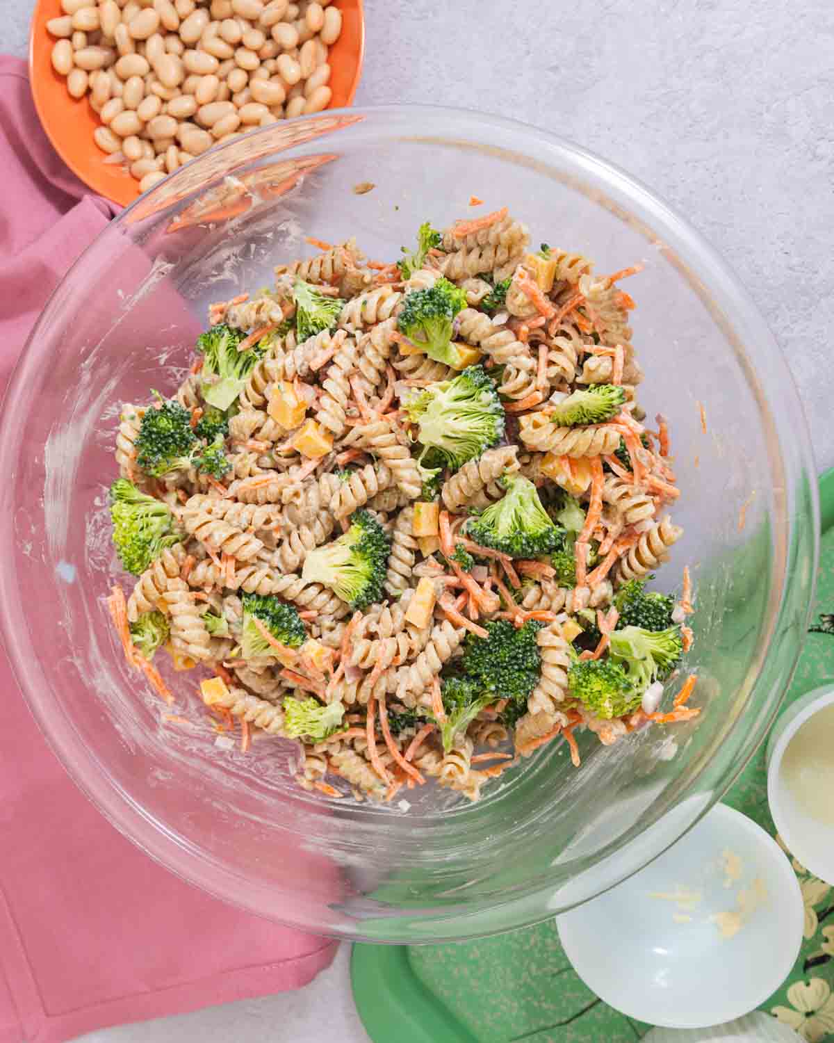Large glass bowl filled with broccoli cheddar pasta salad.