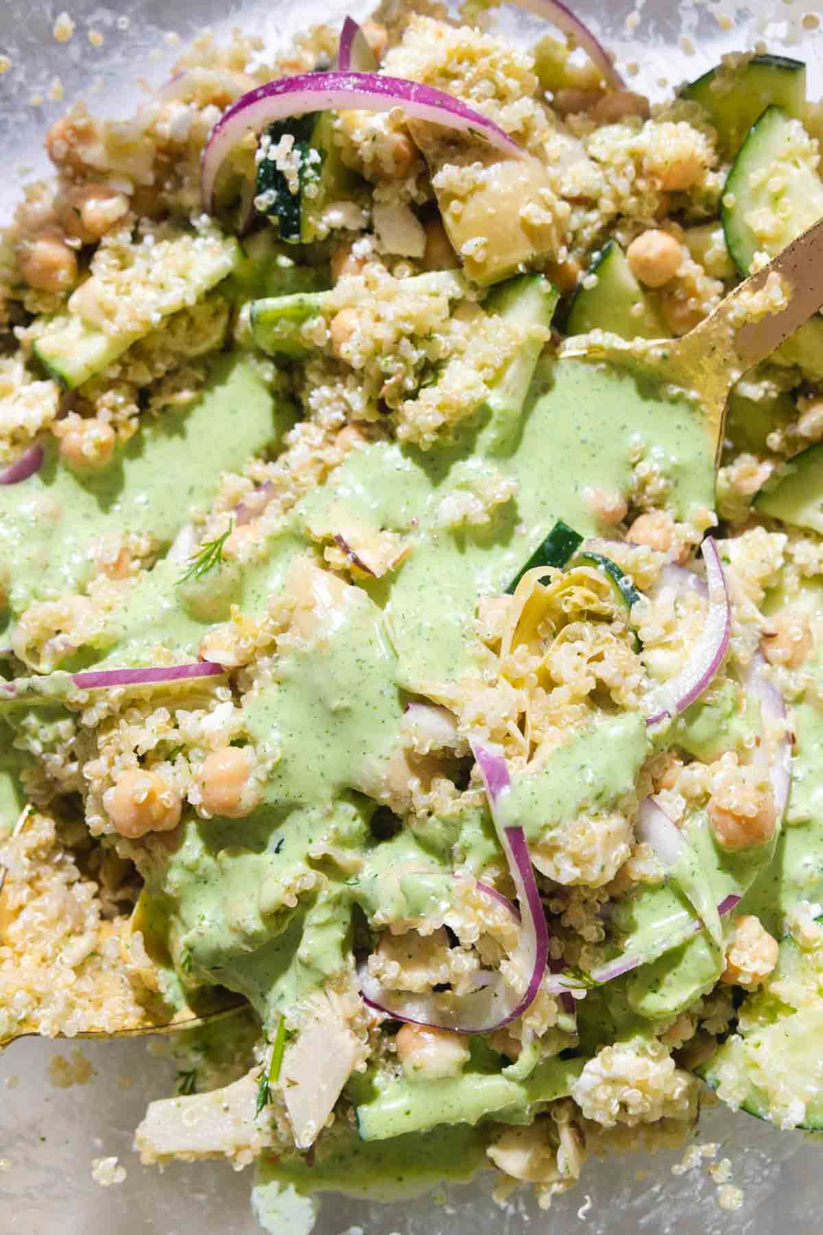 Close up of green salad dressing drizzle on the quinoa salad.