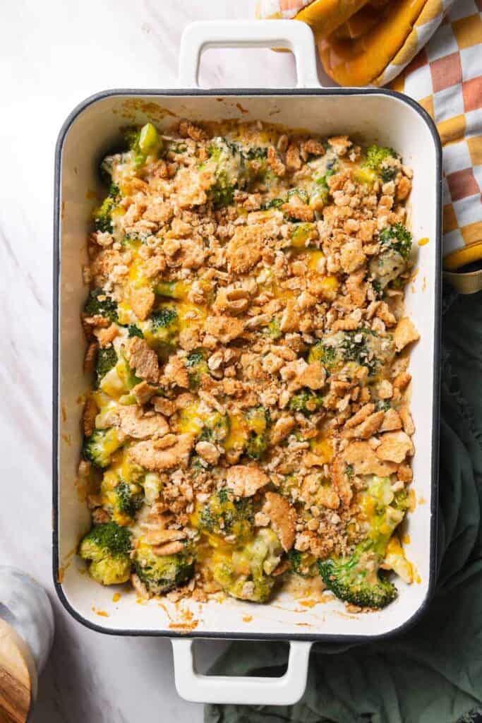 Top down view of rectangular white enamel dish filled with cracker topped broccoli casserole.