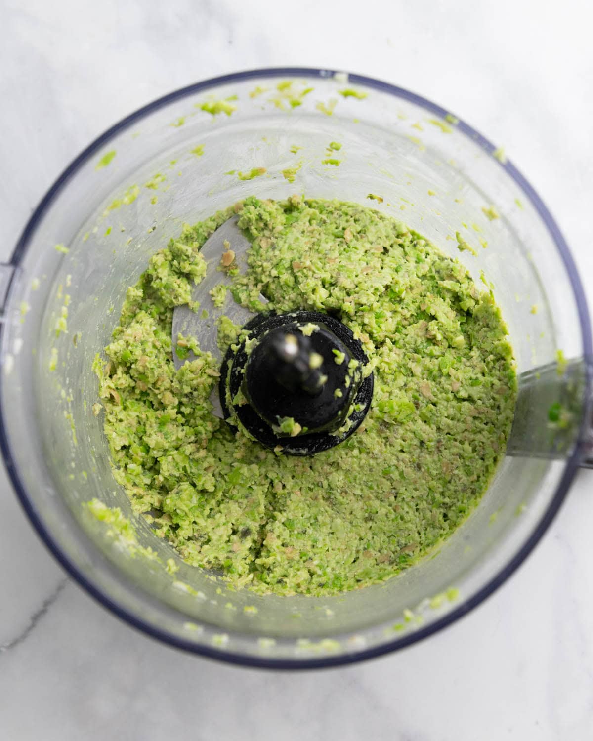 Food processor filled with edamame pea dip.